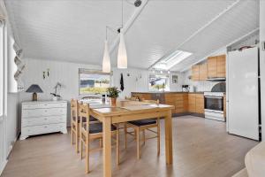 a kitchen with a large wooden table and chairs at SJ253-Haderslev-Vikaerparken-89 in Haderslev +14 photos