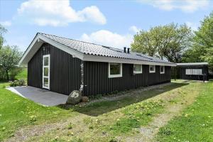 a small black house with a grass yard at SJ253-Haderslev-Vikaerparken-89 in Haderslev