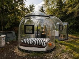 a gazebo with a couch in it in a yard at Skyhomes Bubble Hotel in Prague