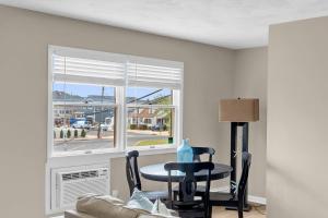 a living room with a table and a window at Between Tides 2BR Walk to Beach Unit C in Seaside Park