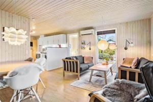 a kitchen and living room with a couch and a table at SJ232-Hejls-Humlevaenget-8 in Hejls +11 photos