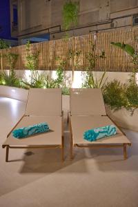 two chairs sitting next to each other on a patio at Perea Fiore Suites in Perea +131 photos