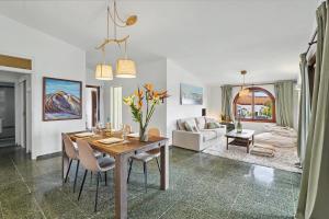 a dining room and living room with a table and chairs at Private Pool And Ocean Views in Chayofa