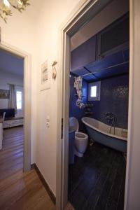 a bathroom with a tub and a toilet and a sink at EMERALD Villa in Kithnos +27 photos
