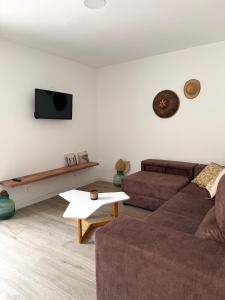 a living room with a couch and a table at Casa Silvestre in Puigmoreno
