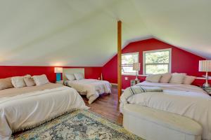 a bedroom with two beds and a red wall at Waterfront Bellingham Bliss: Steps to Beach! in Bellingham