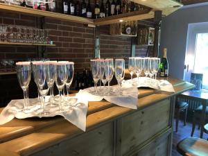 a group of wine glasses sitting on a bar at Pension und Restaurant La Casa in Undeloh