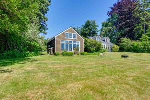 a home with a large yard with a house at Waterfront Bellingham Bliss: Steps to Beach! in Bellingham