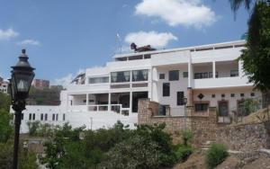 a white building with a street light in front of it at Casa Zuniga Extended Stay in Guanajuato