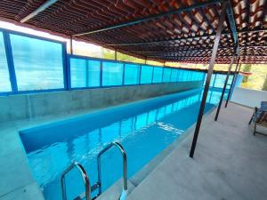 a large swimming pool with blue water in a building at Casa Zuniga Extended Stay in Guanajuato
