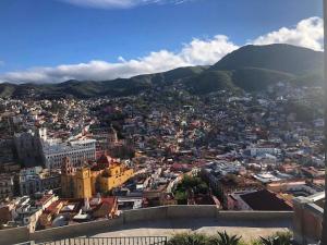 a view of a city with mountains in the background at Casa Zuniga Extended Stay in Guanajuato