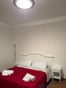 a bedroom with a bed with two towels on it at Troina rooms in Troina +2 photos