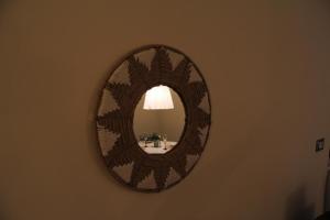 a mirror hanging on a wall in a room at Il nido di Acqui in Acqui Terme