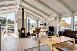 a living room with a fireplace and a table at LN1789-Hjorring-Indemarken-44 in Hjørring