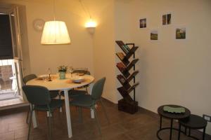 a dining room with a table and chairs at Il nido di Acqui in Acqui Terme