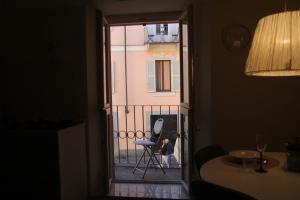 a person standing on a balcony looking out a window at Il nido di Acqui in Acqui Terme