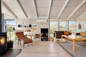 a living room filled with furniture and a fireplace at LN1789-Hjorring-Indemarken-44 in Hjørring