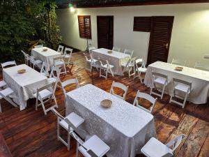 a group of tables and chairs with white tables at Barreo Nova Eco Resort in Abrafo