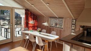 a dining room with a white table and chairs at LN1600-Hjorring-Indemarken-36 in Hjørring