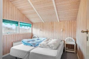 a bedroom with a bed in a wooden room at LN1600-Hjorring-Indemarken-36 in Hjørring