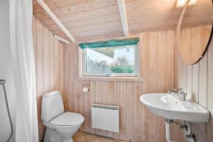 a bathroom with a toilet and a sink at LN1600-Hjorring-Indemarken-36 in Hjørring +11 photos