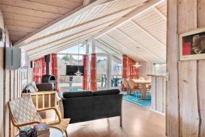 a living room with a couch and a table at LN1600-Hjorring-Indemarken-36 in Hjørring