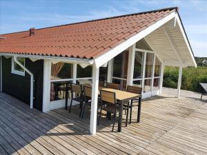 a pavilion with a table and chairs on a deck at LN1600-Hjorring-Indemarken-36 in Hjørring