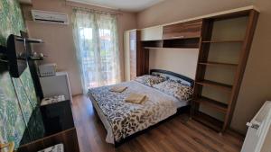 a bedroom with a bed and a book shelf at Napsugár Resort in Siófok