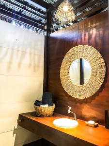 a bathroom with a sink and a mirror at Casa Shaka in Atins