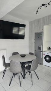 a kitchen with a table and chairs and a refrigerator at Paralia Sea View Suites in Paralia Katerinis