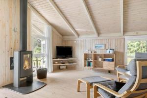 a living room with a fireplace and a tv at LN1959-Hirtshals-Tangen-3 in Hirtshals