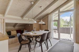 a kitchen and dining room with a table and chairs at LN1959-Hirtshals-Tangen-3 in Hirtshals