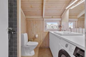 a bathroom with a toilet and a sink at LN1959-Hirtshals-Tangen-3 in Hirtshals +17 photos