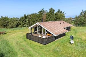 a small house with a roof on a field at LN1959-Hirtshals-Tangen-3 in Hirtshals