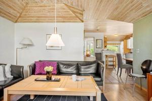 a living room with a couch and a table at SJ296-Hejls-Ae-Skovbryn-37 in Hejls