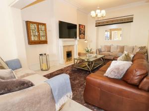 a living room with a couch and a fireplace at The Causeway in Llandudno