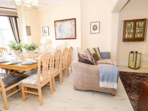 a living room with a dining room table and chairs at The Causeway in Llandudno