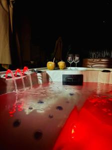 a table with wine glasses on top of it at Dejavu ROOMS & SPA in Assoro