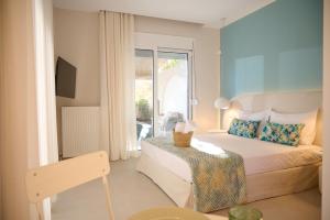 a hotel room with a bed and a balcony at Perea Fiore Suites in Perea