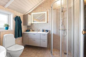 a bathroom with a shower and a toilet and a sink at SJ285-Bjert-Kystvej-64-A in Åbjerg +19 photos