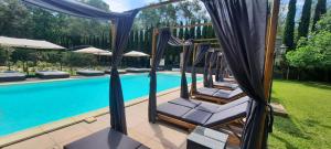 a swimming pool with two lounge chairs next to at Château Rieutort in Saint-Pargoire