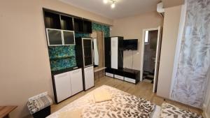 a room with black and white cabinets and a television at Napsugár Resort in Siófok