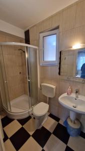 a bathroom with a shower toilet and a sink at Napsugár Resort in Siófok +38 photos
