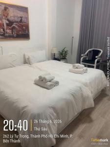 a white bed with towels on top of it at Financeer Hotel in Ho Chi Minh City