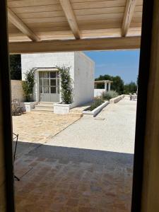 an outside view of a building with a patio at Trullo botanico in Ceglie Messapica +64 photos