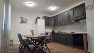 a kitchen with a table and chairs and a refrigerator at Krka Hideaway in Lozovac +14 photos