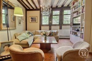 a living room with a couch and a table and chairs at Hôtel des ducs de bretagne in Saint-Brieuc