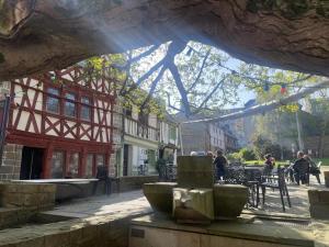 a fountain in the middle of a street with a building at Hôtel des ducs de bretagne in Saint-Brieuc