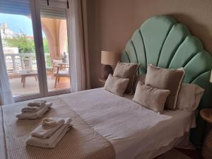 a bedroom with a large bed with towels on it at MD Villa con piscina en Mareny Beach in Mareny Blau +80 photos