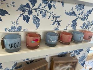 a shelf with a bunch of cups on it at HaRE Ferienwohnungen een in Langeneß +25 photos